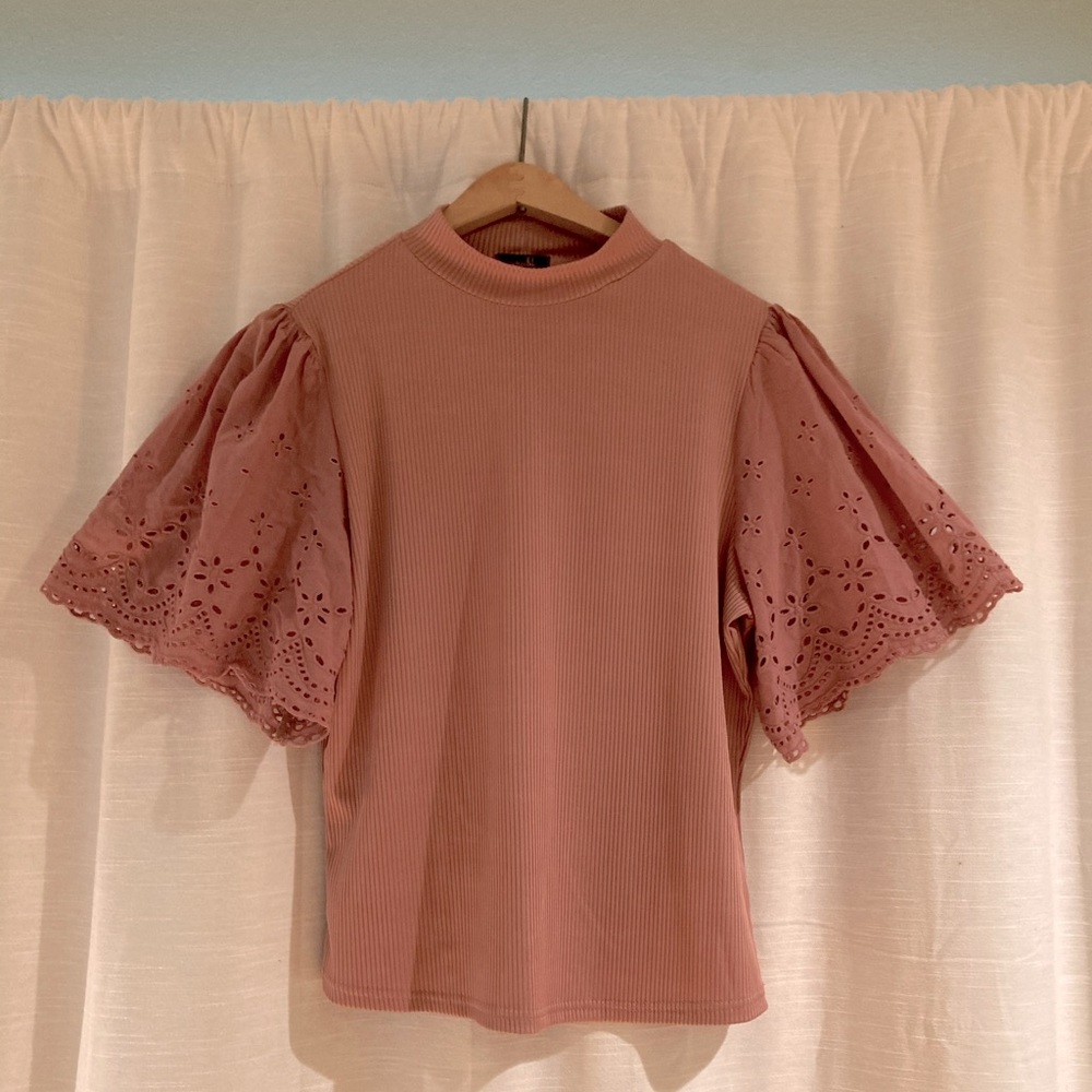 Pink Top with Ilet sleeves.
